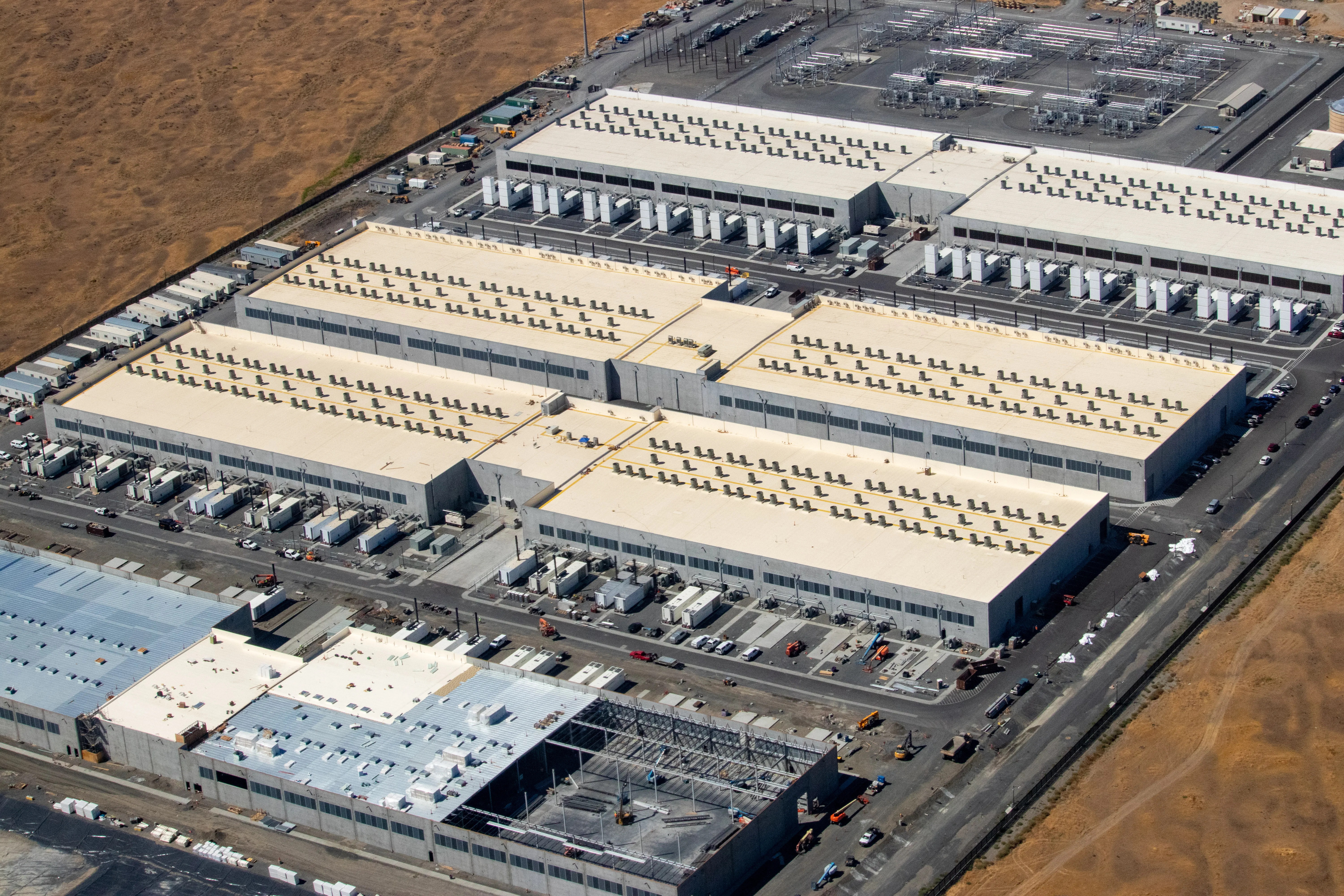 Rows of servers in a massive data center — the infrastructure behind AI